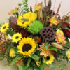 in a wooden box filled with fall array of flowers