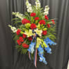 This striking standing spray is a heartfelt tribute to courage, service, and