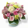 This beautiful small arrangement has white roses, light pink spray roses, pink