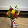 A white ceramic vase filled with fresh fall flowers. 