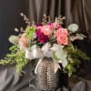 Beautiful seasonal blooms in a custom vase.