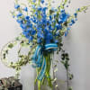 Beautiful light blue delphinium striking and vibrant in a custom container adorned