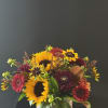 Sunflowers, dahlias, gerbera daisies, and other fall blooms come together in this