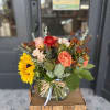 A warm mix of fall florals in coral, red, and yellow, and