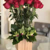 A unique presentation of 24 long-stemmed, ruby-red Roses, in a beautiful base