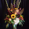 &ldquo;Autumn Retreat&rdquo; is a striking seasonal arrangement featuring sunflowers, gladiolus, lilies, roses
