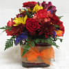 Glass cube w/ burlap and ribbon band.  Roses, seasonal colored mums