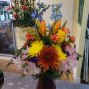 Vase arrangement filled with assorted flowers and colors of the season. 