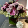 A beautifully designed abundance of Amnesia roses, plum lisianthus, amaranth, eucalyptus, and