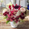 Sweet, romantic assortment of flowers arranged in a short design within a