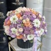 Elegant Arrangement in a Black Vase
This refined floral composition showcases a graceful