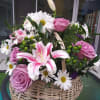 A handled basket filled with, roses, pink stargazer lillies, daisy mums, Monte