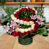 This is a lush and elegant floral arrangement designed in a round