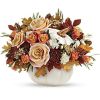 Elegant cr&egrave;me roses blend with the heartwarming hues of autumn in this