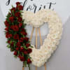 This sympathy heart is made with all white roses and accented with