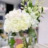Half Moon and Orchids Arrangement: Oval clear vase with seashells at the