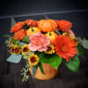A warm gathering of gerbera daisies, mums, spray roses, carnations and a