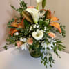 Cala lilies, lilies and roses make up this sweet fall arrangement. Composed