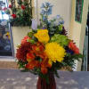 Mixed seasonal blooms arranged in a glass vase 