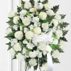 White flowers in an oval shape on a wreath stand with a