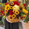 Experience the exquisite fall flower selection in a freshly carved pumpkin. 