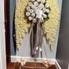 This elegant funeral arrangement is designed in the shape of angel wings