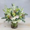 Green, white, and soft pink florals come together to create this flowy