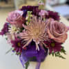fresh flowers in purple cube vase 