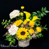 A radiant mix of sunflowers, yellow calla lilies, Quicksand blush roses, and