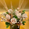 This elegant and timeless arrangement features creamy white roses as the centerpiece