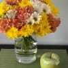 This arrangement is a vibrant and cheerful bouquet, perfect for brightening up