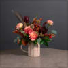 Ivory pitcher with multi-color painted pattern filled with roses, safari sunset protea
