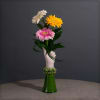 A Victorian style hand vase holding a bright bunch of gerbera daisies