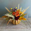 A beautiful nod to the autumn season, this arrangement tucked into an