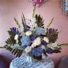 Deep blue hydrangea with gladiola, spider mums and curly willow. Tall and