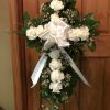 Our Carnation Cross is highlighted with a dozen carnations with greenery and