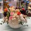 White hydrangea, orange ranunculus, pink spray roses, burgundy dahlia, white hypericum berries