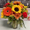 Sunflowers, orange gerberas, red carnations, orange daisy, solidago, red berries with greenery