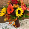 This colorful fall design includes Sunflower, Gerbera daisies, Roses, daisies and Seasonal