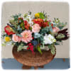 This arrangement is in a long container and has it all! Roses