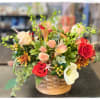 This beautiful arrangement is in a woodchip cedar basket. It contains roses