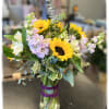This arrangement consists of sunflowers, stock and alstroemeria.
