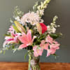 Lilies, alstromerias and daisies in a vase arrangement