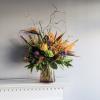 This makes a statement with protea, bird of paradise, orchids and other