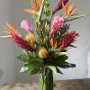 This makes a statement with protea, bird of paradise, orchids and other