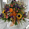 A beautiful mix of summer blooms, including marigolds, sunflowers, and more.
