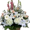 Snapdragons, lilies, roses, mini carnations and hydrangeas arranged in a basket. 
White