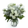A timeless display of grace and beauty, this arrangement features pristine white