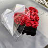 Black heart-shaped acrylic box with beautiful red roses 