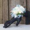 Classic white and light blue blooms and greenery are showcased on a